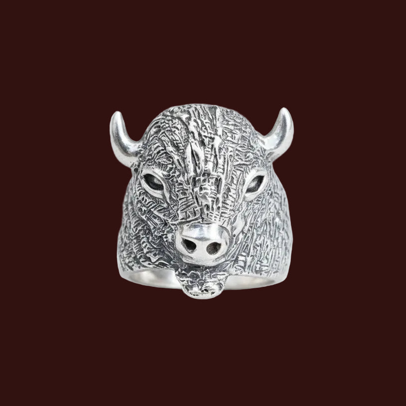 Silver bull head ring on a light gray background